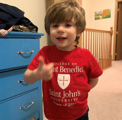 Little boy wearing a Saint Ben's and Saint John's t-shirt
